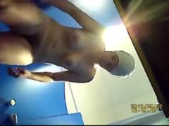 While that chick is getting dressed, a gorgeous hottie with huge whoppers is surreptitiously filmed.